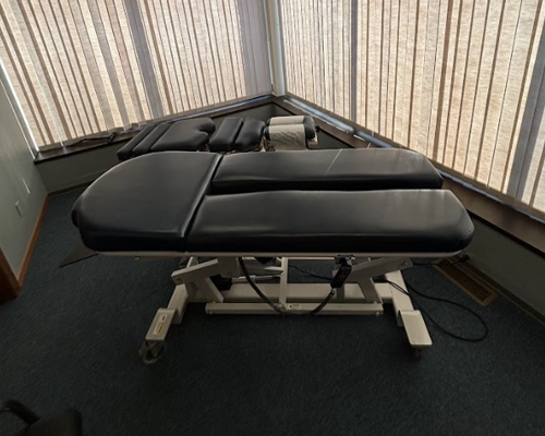 Treatment table used for spinal decompression at Kentwood Family Chiropractic