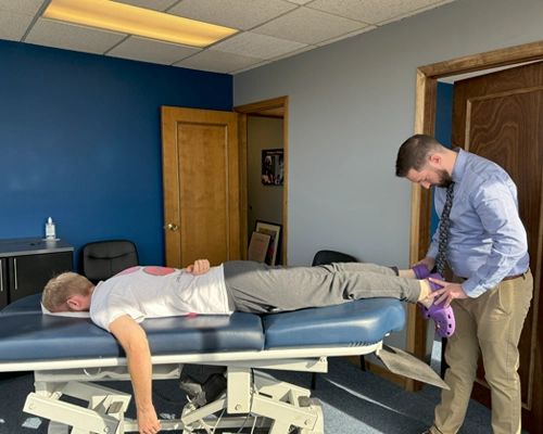 Dr. Paul McAllister delivering a gentle Activator adjustment at Kentwood Family Chiropractic