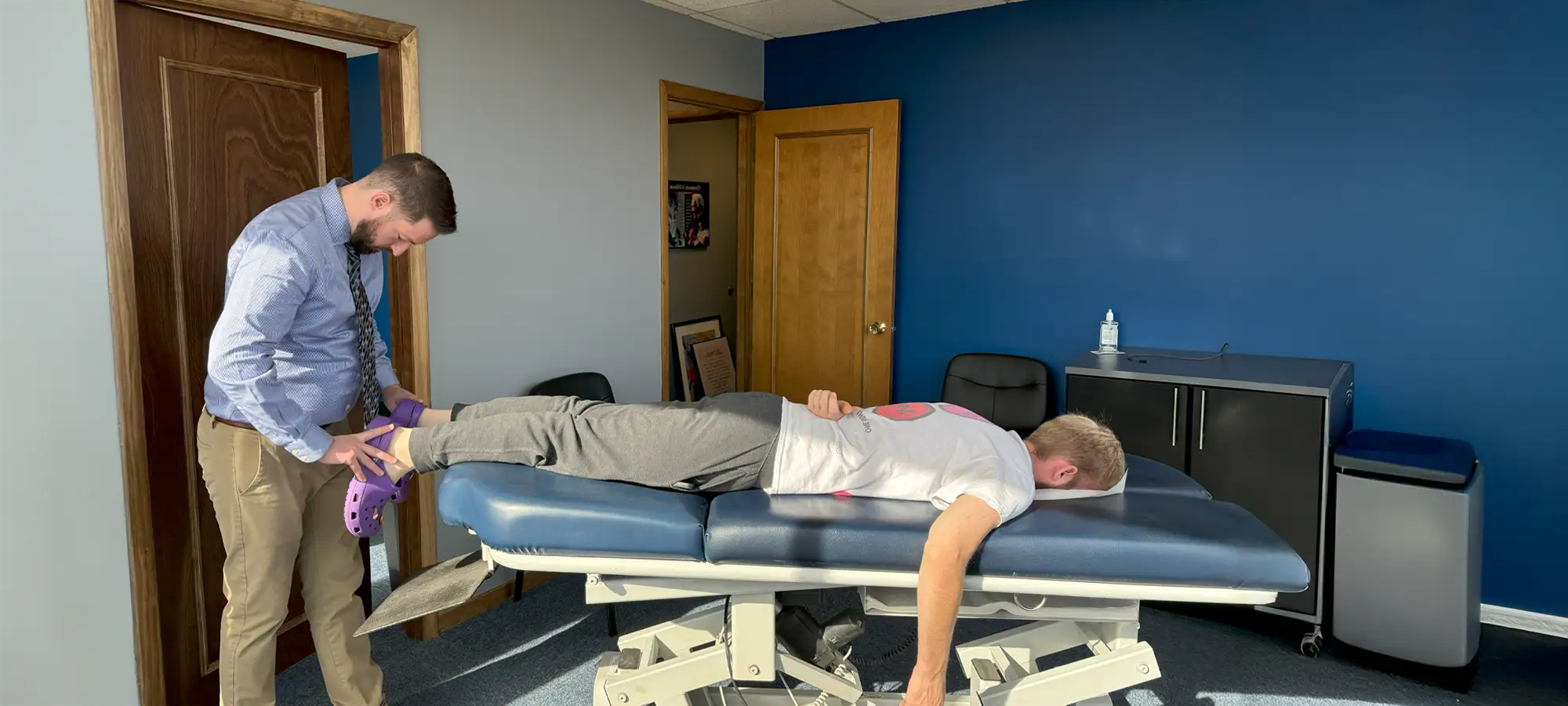 Dr. Paul McAllister performing an Activator Methods adjustment at Kentwood Family Chiropractic