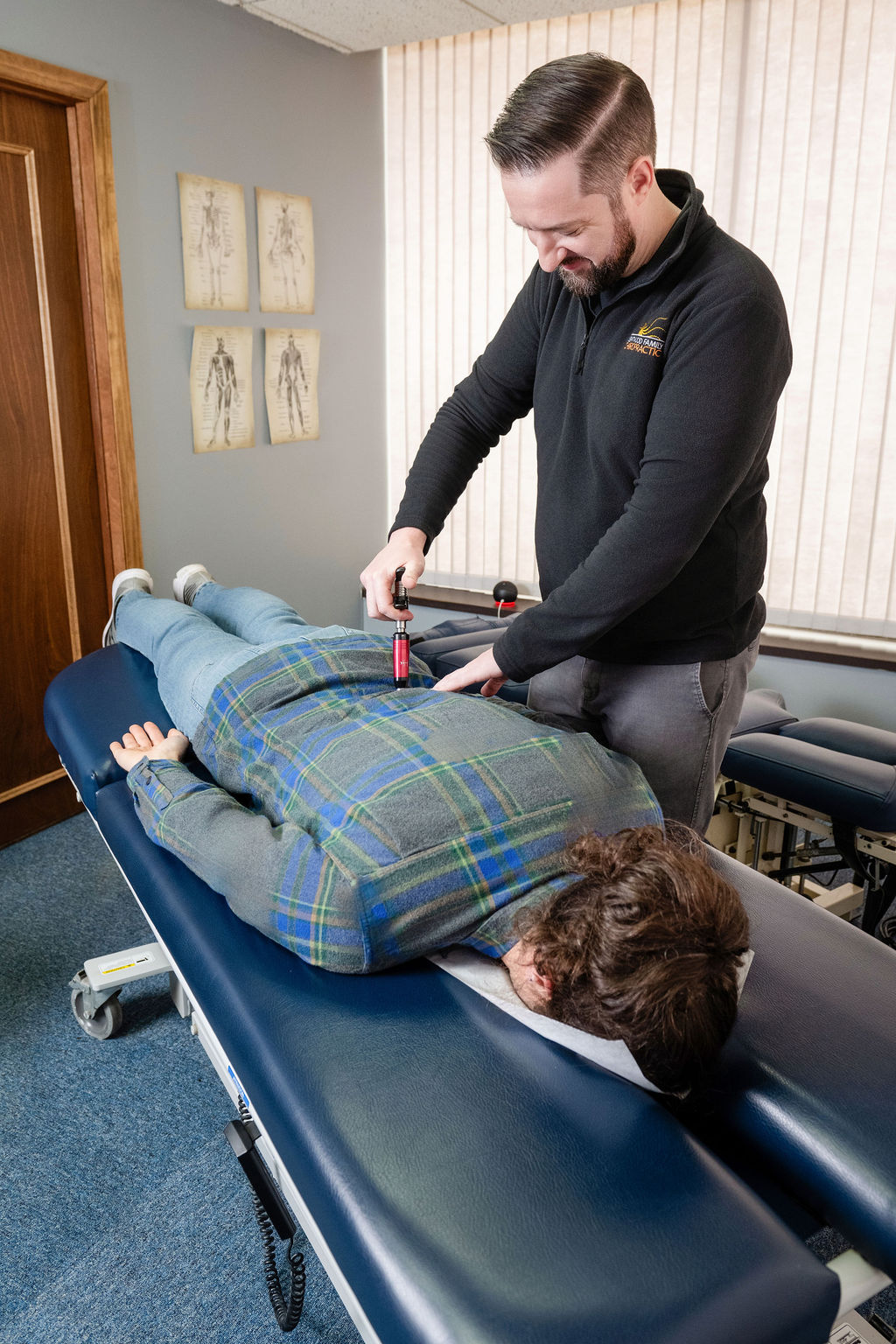 Dr. Paul McAllister treating a patient with the Activator instrument at Kentwood Family Chiropractic