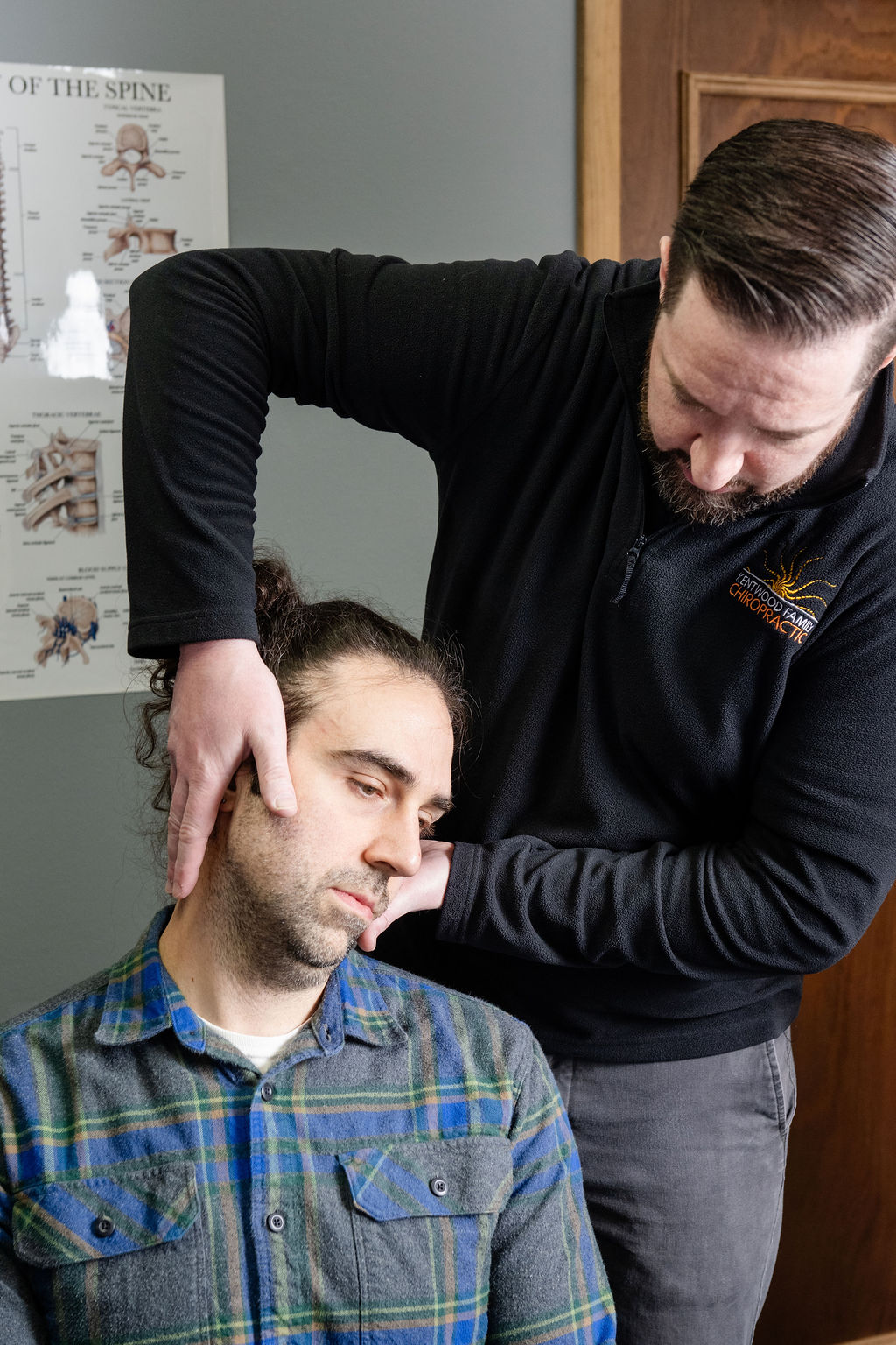 Dr. Paul McAllister assessing the upper neck of a headache patient at Kentwood Family Chiropractic