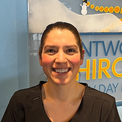 licensed Massage Therapist Whitney Phillips Smiling In Scrubs