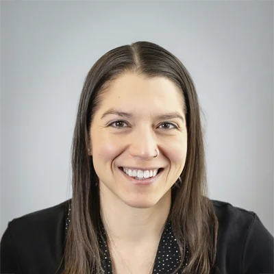 Licensed Massage Therapist Whitney Phillips Smiling In Scrubs